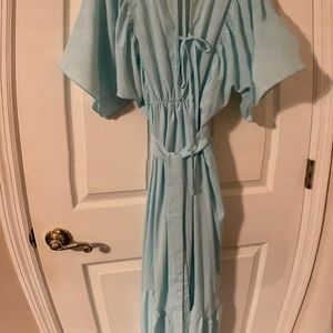 See through blue v neck dress with ties in the back and a tiered skirt